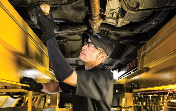 car mechanic doing an oil change