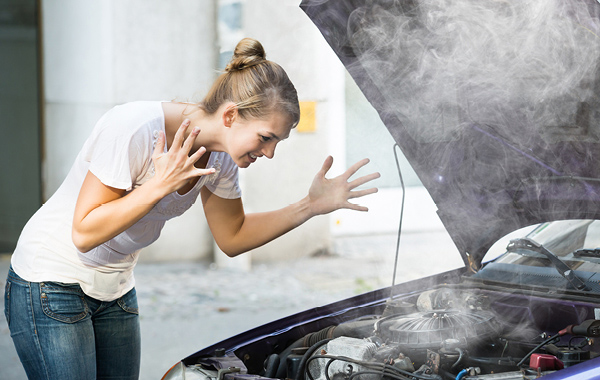 Woman frustrated with smoking car