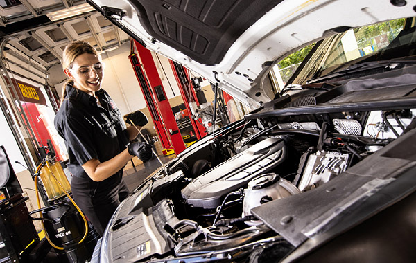 Mechanic working on car engine