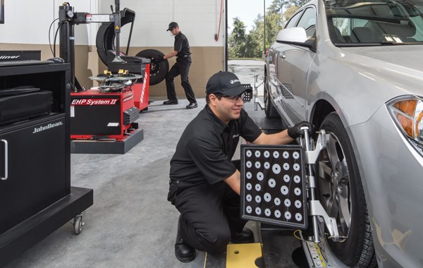 Jiffy Lube car expert doing a tire alignment