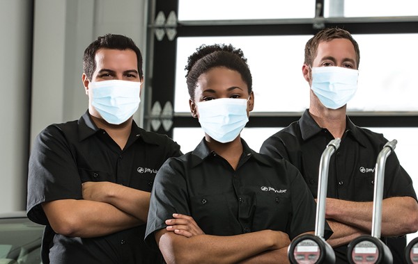 Jiffy Lube car experts wearing protective masks for COVID 19 precautionary measures