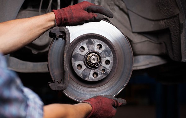 A certified Jiffy Lube® brakes specialist doing a full-scope brake inspection