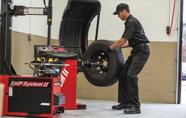 Jiffy Lube car expert fixing a tire