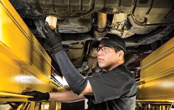 Jiffy Lube car expert doing a quick oil change