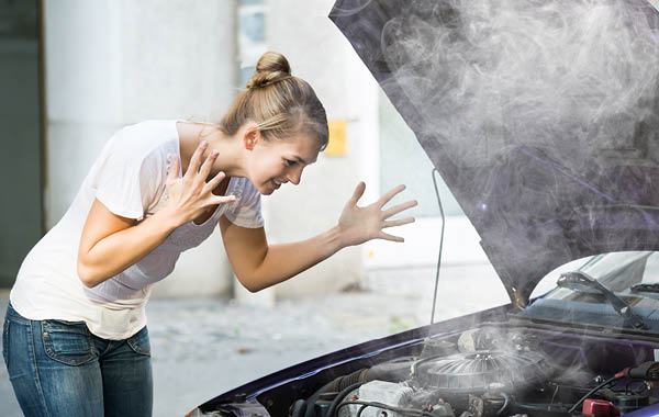 Woman frustrated with smoking car