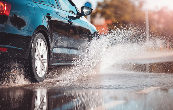 Car splashing through puddle