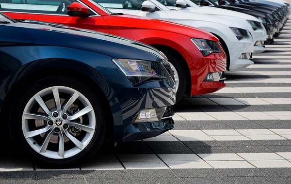 line of cars in different colors on a parking lot