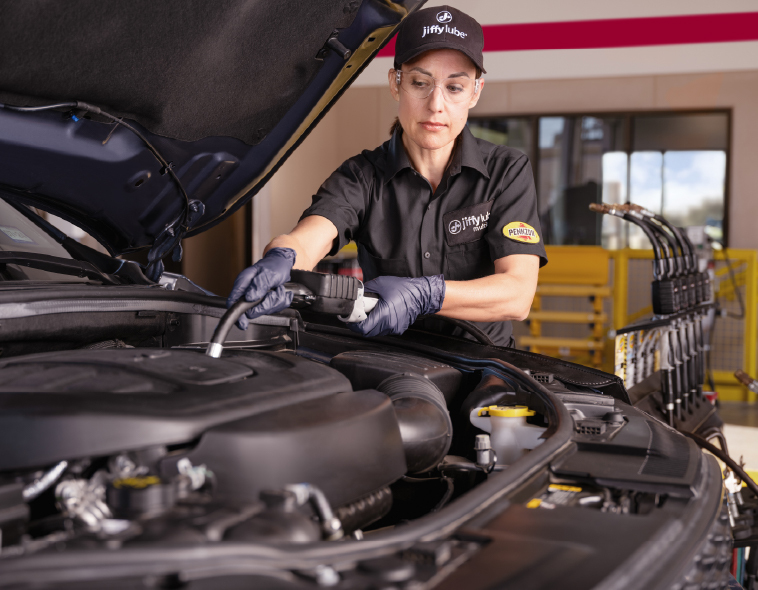 Woman performing oil change desktop sized artwork