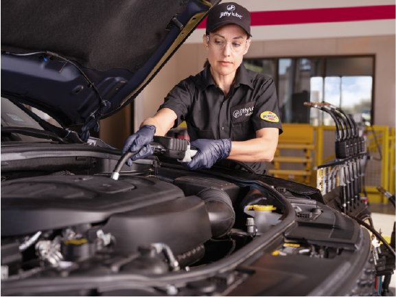 Woman performing oil change mobile sized artwork